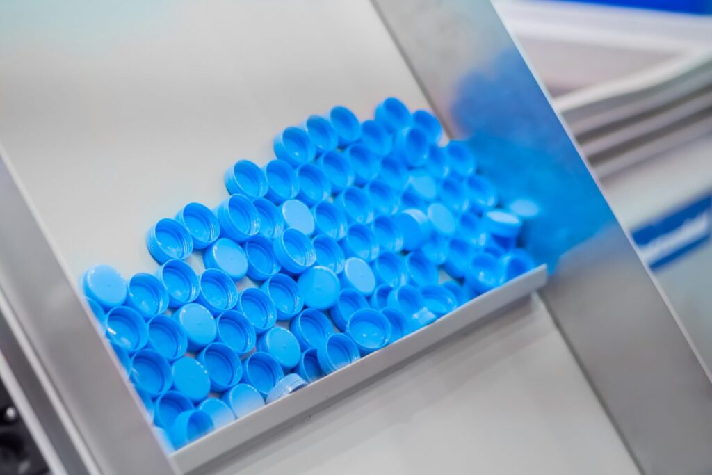 Compression moulded blue plastic bottle caps