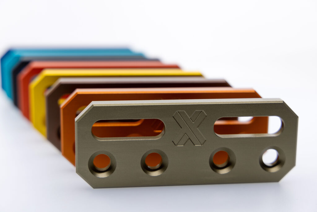 Colored anodized CNC-machined aluminum brackets with precision slots and mounting holes
