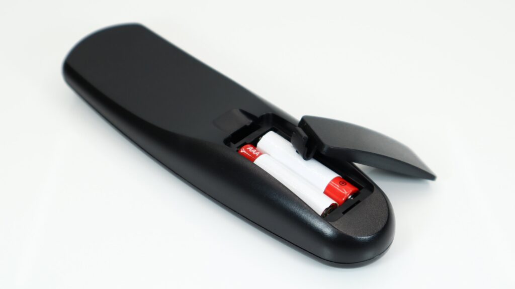 Black TV remote control with a U-shaped snap-fit