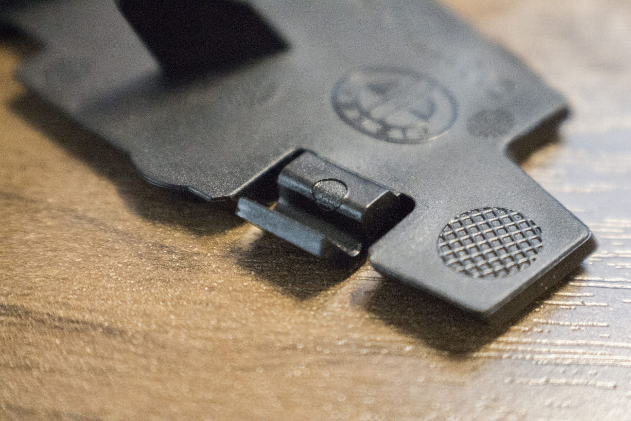 Injection molded black headlight panel with a snap-fit joint