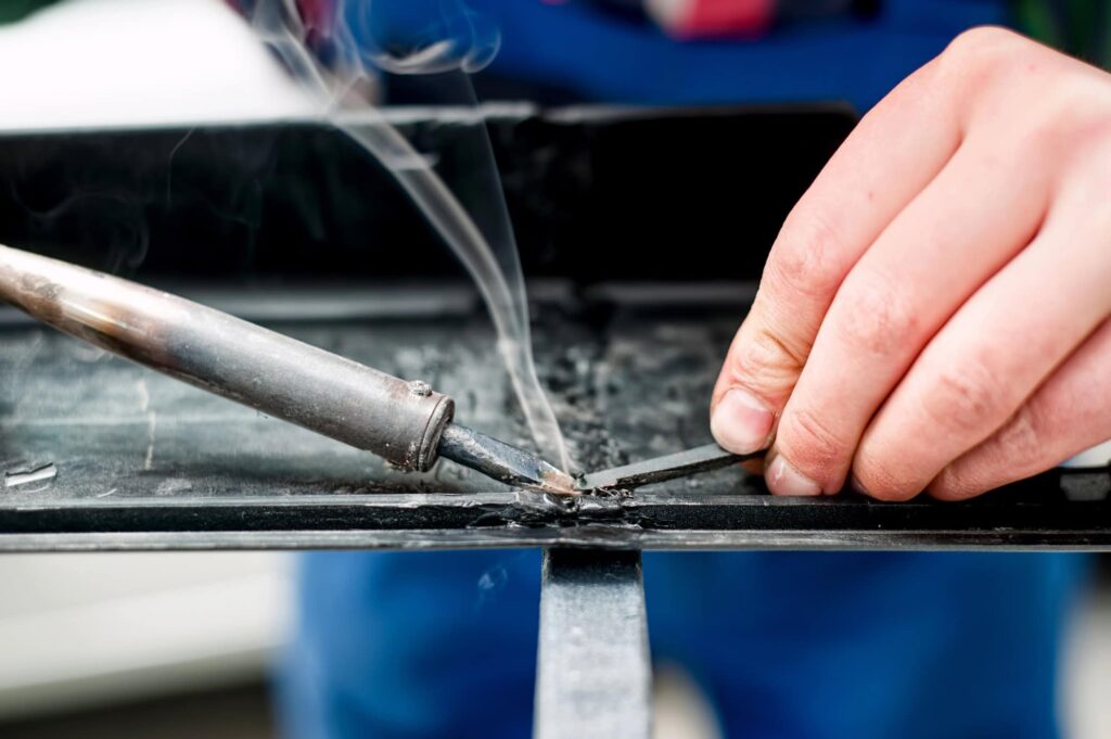 Professional mechanic using a plastic welder