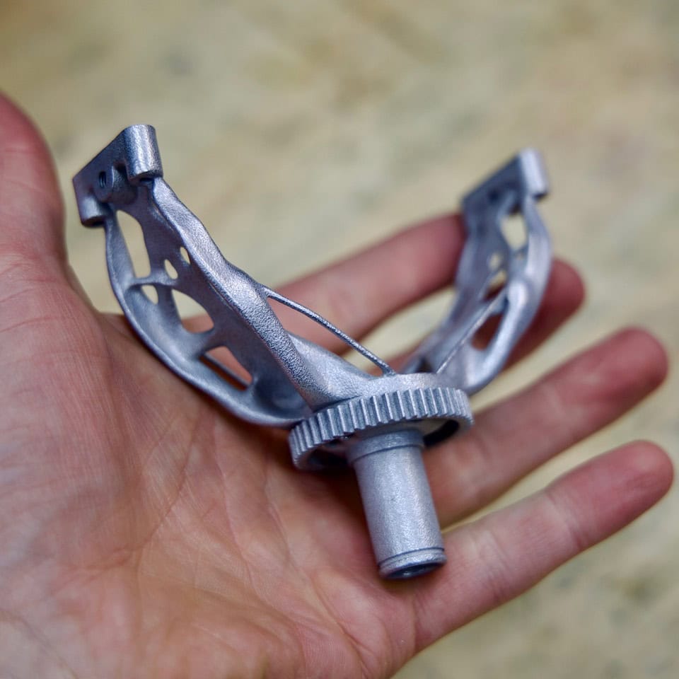 A close-up of the 3D-printed metal part, designed to meet specific structural requirements for optimal performance