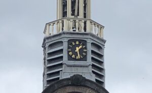 The Pilgrim Fathers Church near Rotterdam, featuring both a clock and a sundial—a historical tradition for accurate timekeeping.