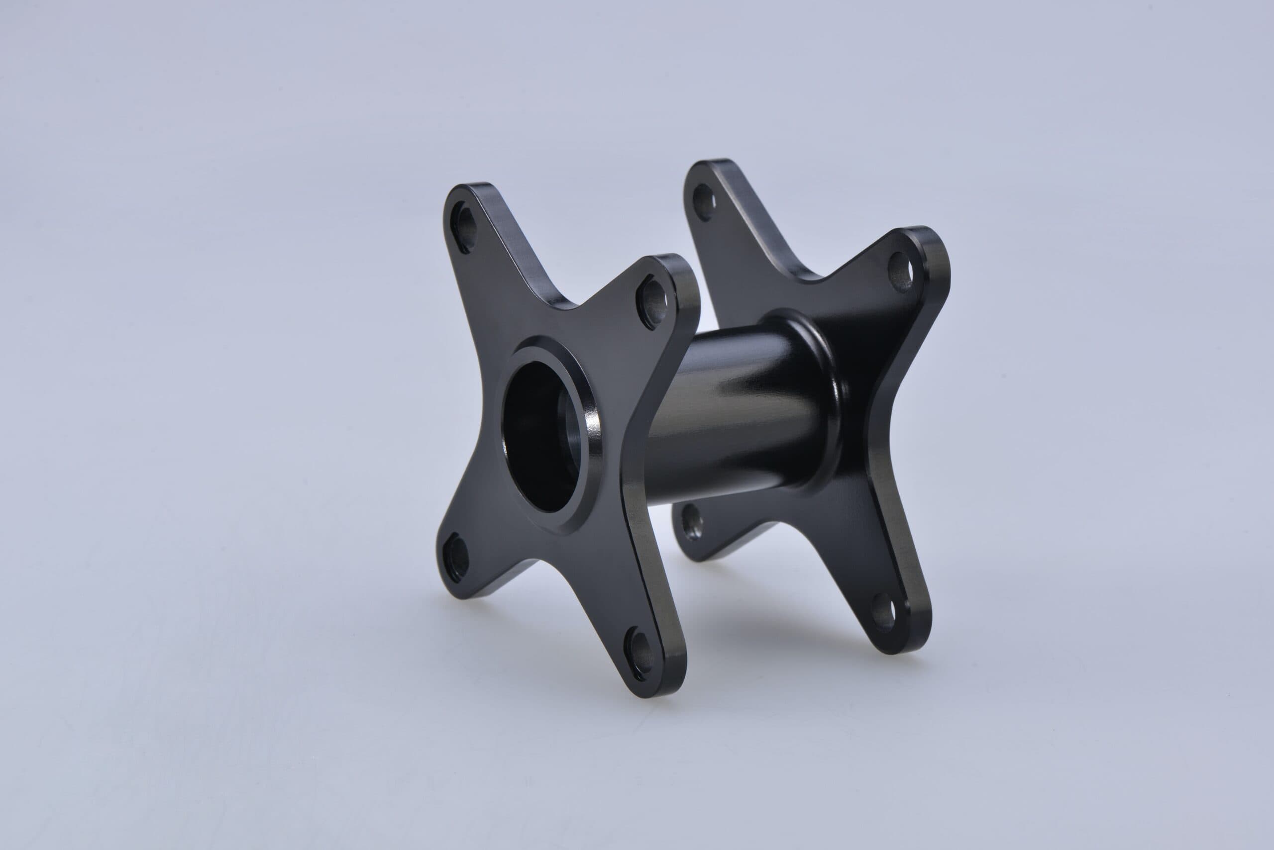 Black anodized CNC-machined metal part with a smooth finish