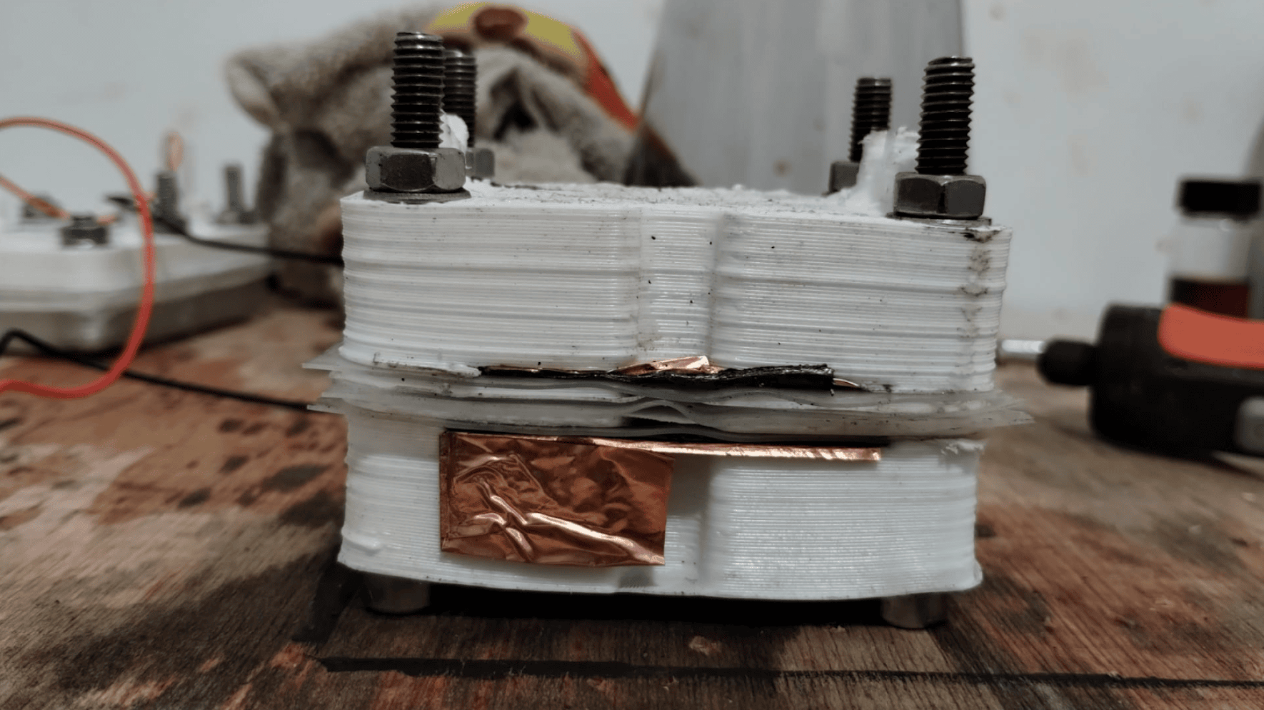 An early prototype of our cell, showing the serious warping of FDM-printed polypropylene parts