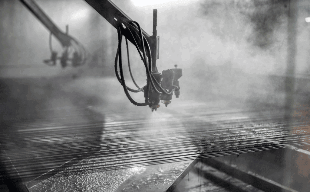 Metal part on a conveyor line being sprayed